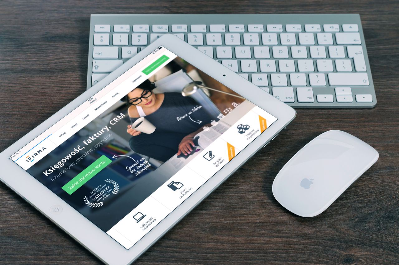 services-01 A tablet with a financial website open, alongside a white keyboard and mouse. Ideal for tech-theme stock images.